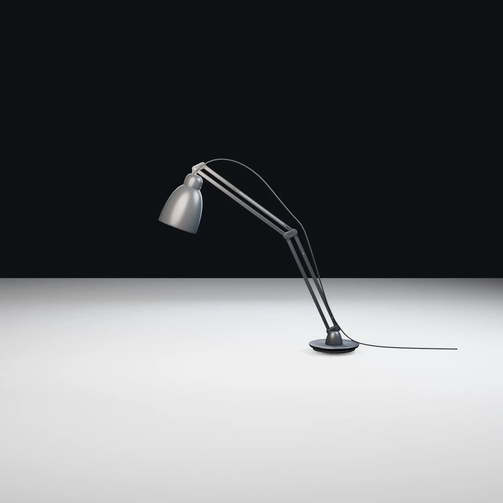 Accepted side view of an articulated Luxo L-1 task lamp with circular base, sprung arms, shade and power cable.